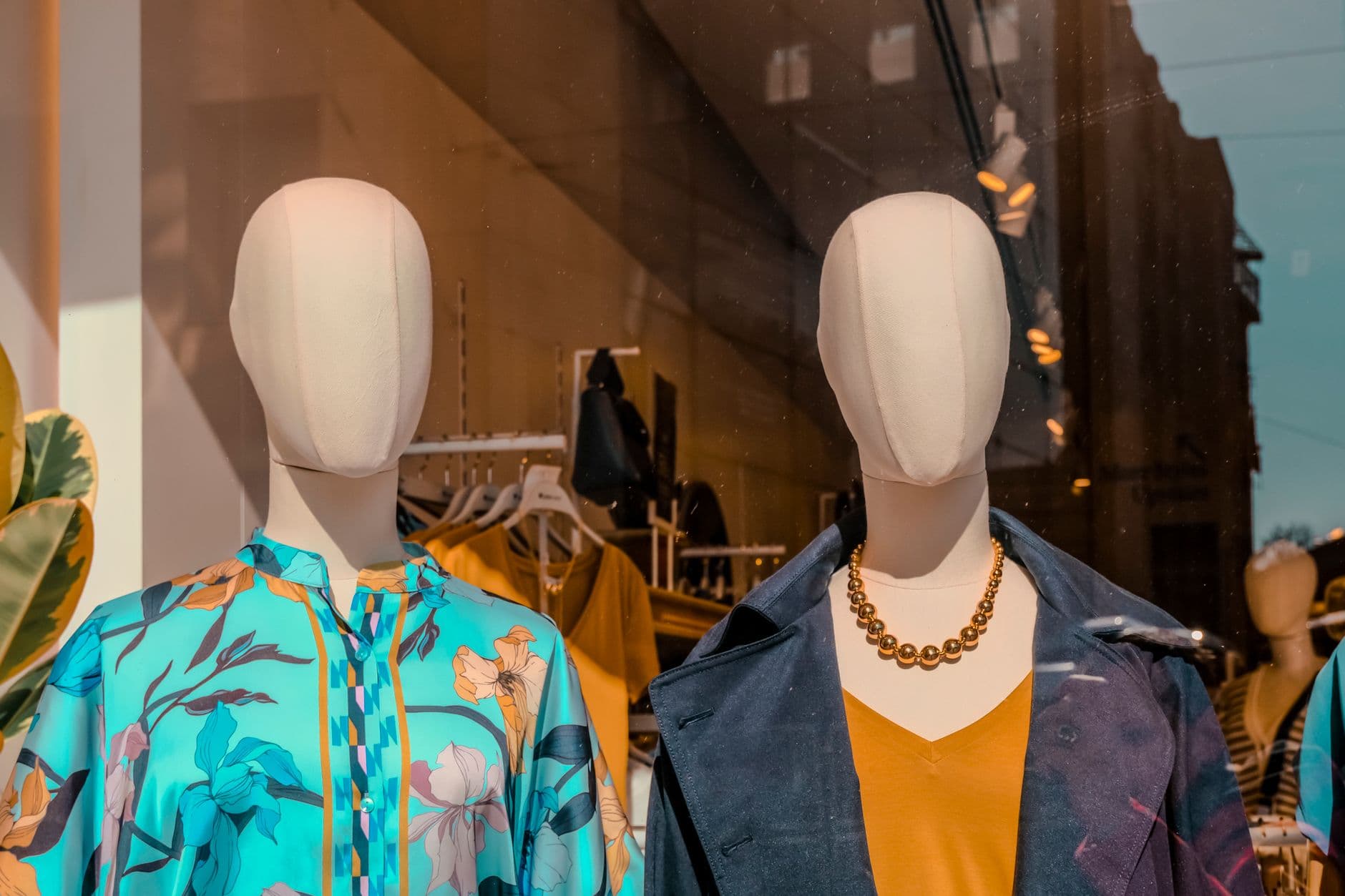 Elegant mannequins display vibrant fashion in an Istanbul boutique window.