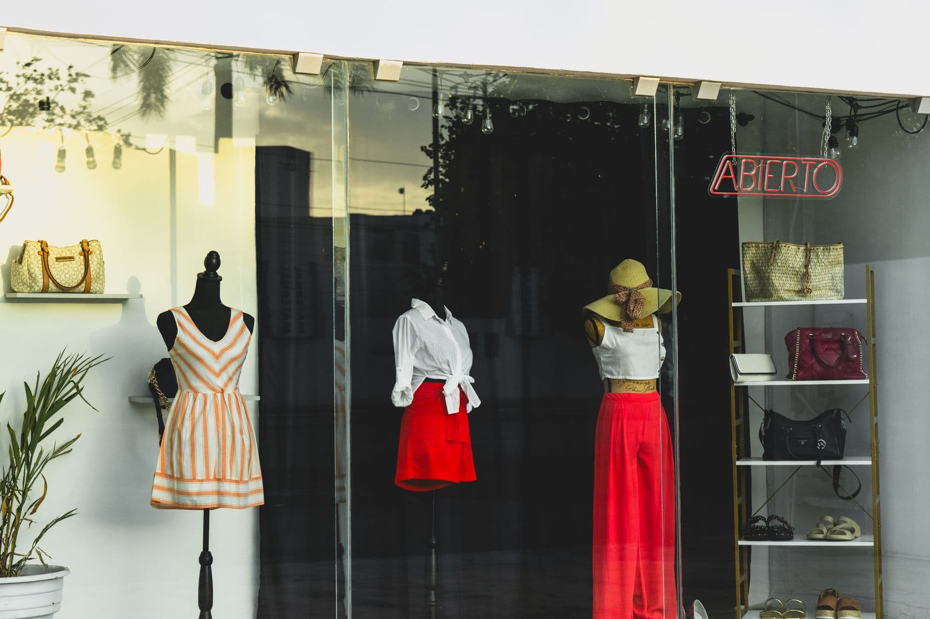 Fashion mannequins in a stylish boutique window display at sunset in Merida, Yucatan.