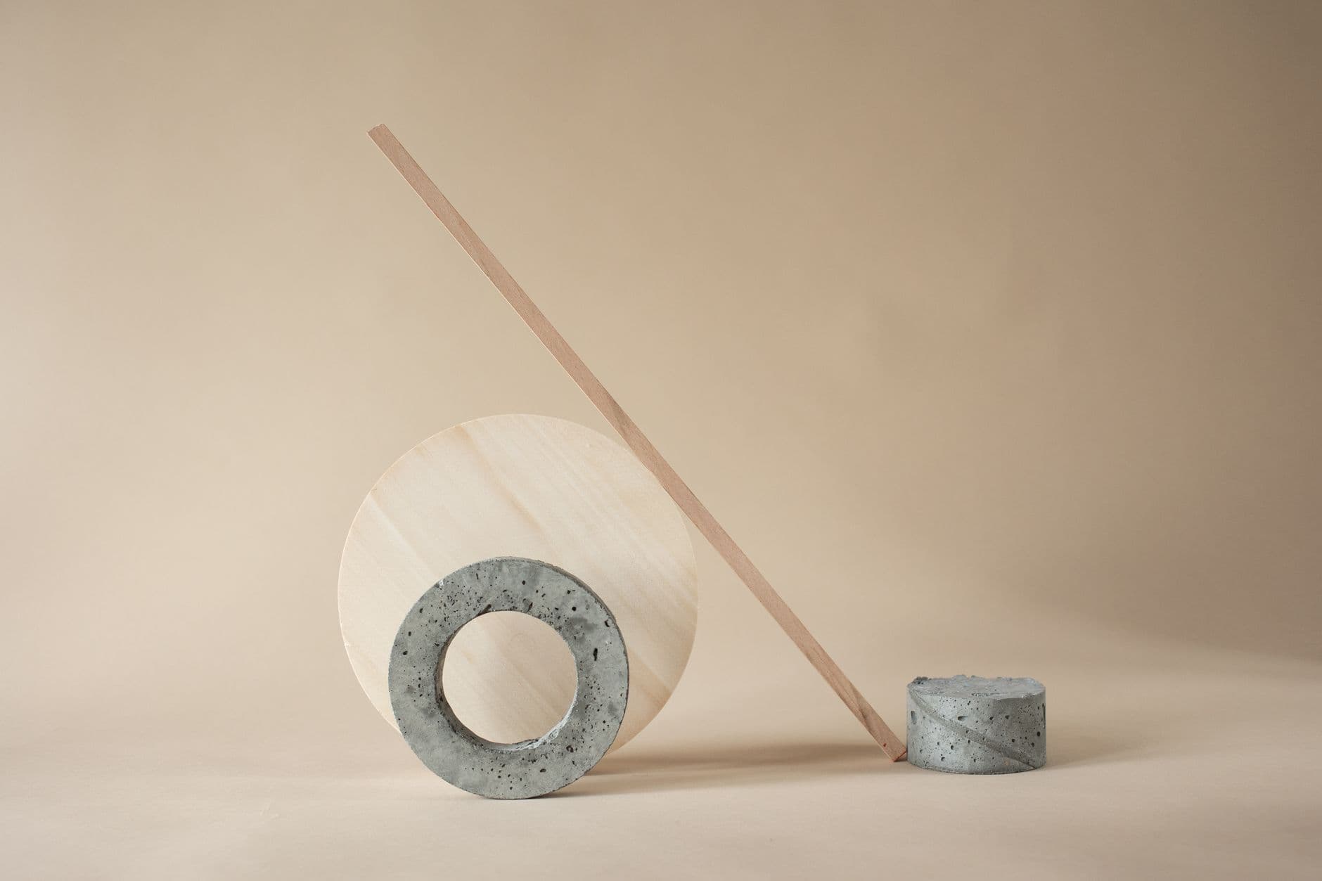 Artistic minimalist arrangement of geometric shapes in neutral tones.