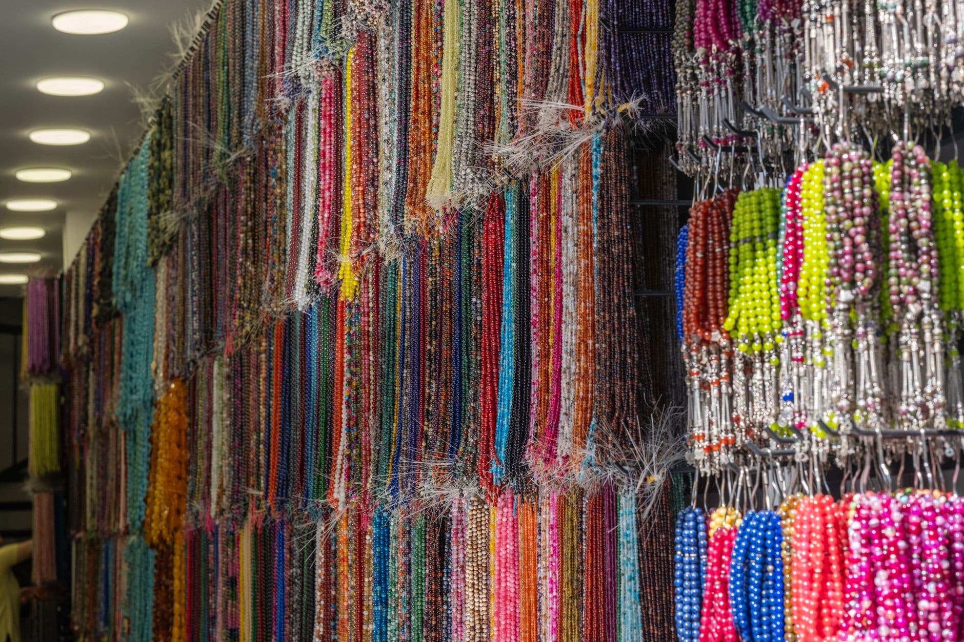 Colorful bead strands displayed in an Izmir market, showcasing local craftsmanship.