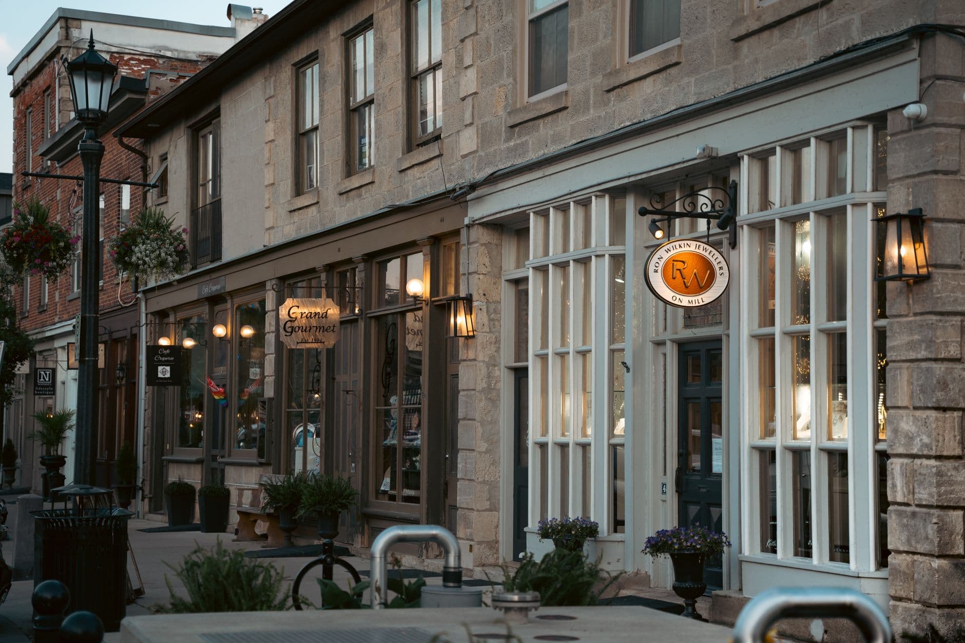 Quaint Ontario street with boutique shops and historic architecture in soft lighting.