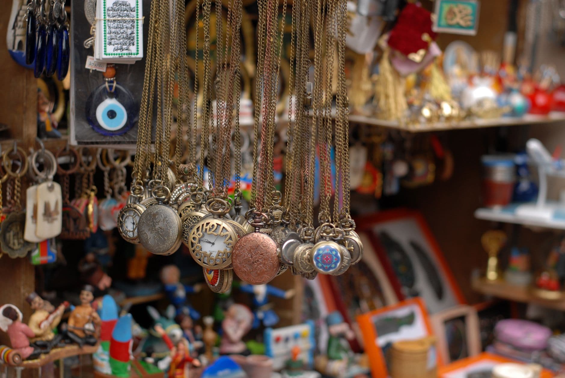 Vibrant assortment of necklaces and trinkets on display at a bustling bazaar stall.