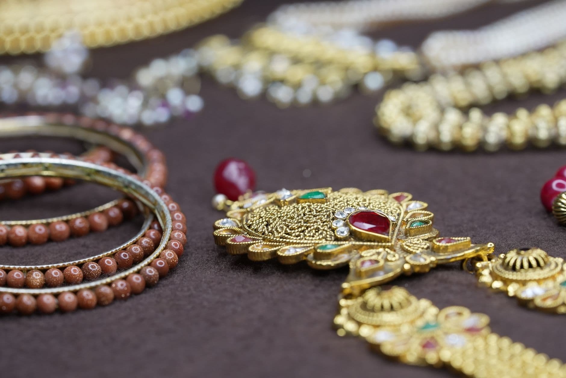 Stunning close-up of intricately designed gold and beaded jewelry showcasing traditional craftsmanship.