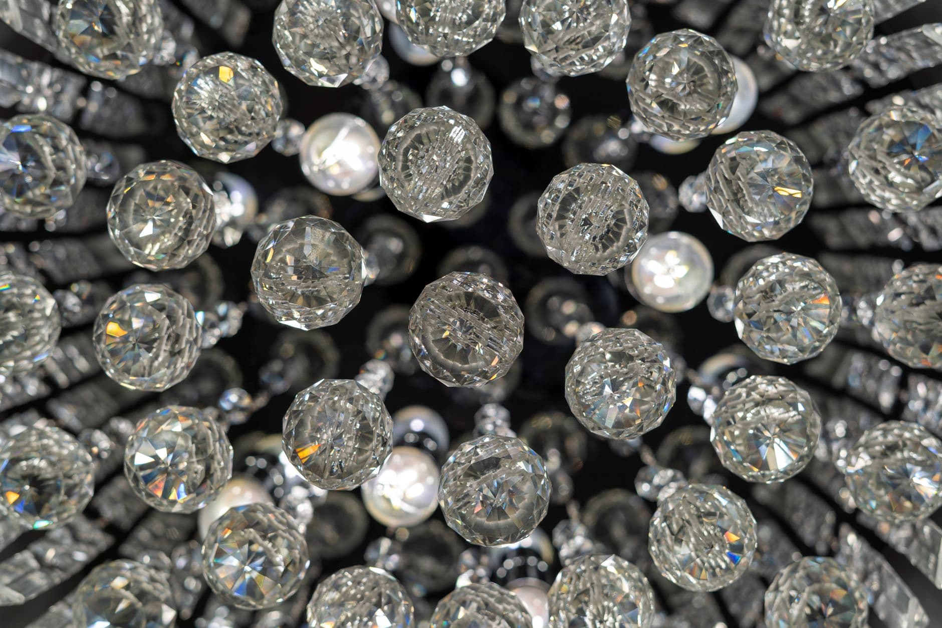 Close-up view of a dazzling crystal chandelier, radiating luxury and elegance.